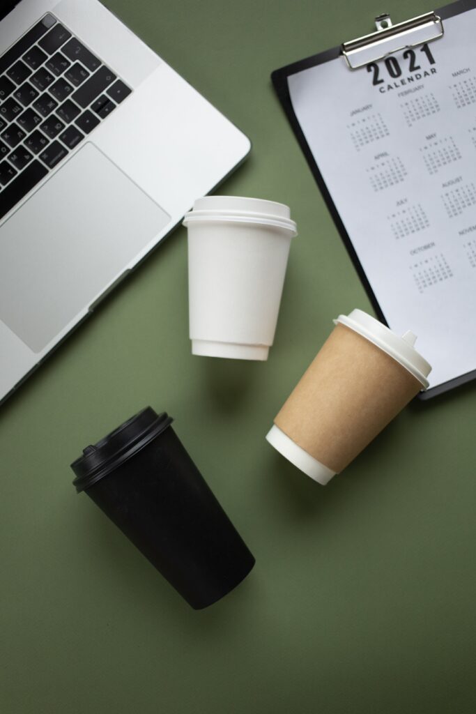 Empty Paper Cups on Green Surface